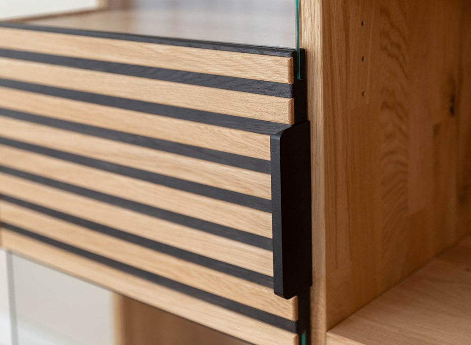 Beleuchtete Standvitrine aus massiver Eiche mit Lamellen | Wohnzimmerschrank Tirano II mit Rückwand in grober Holzstruktur -