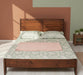 Landhausbett-aus-Massivholz-Klassisches-Vollholzbett-geschwungenes-Kopfteil-wandfarbe-salbei-licht-links